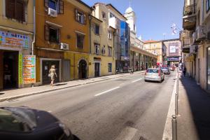 a street with a car parked on the side of the road at Apartments Trend 2 in Rijeka