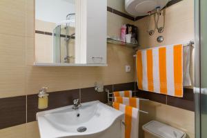 a bathroom with a sink and a toilet at Apartments Trend 2 in Rijeka +31 photos