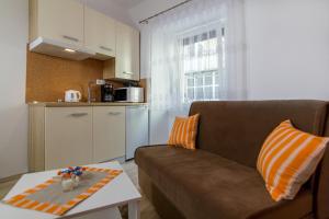 a living room with a couch and a table at Apartments Trend 2 in Rijeka