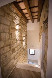 a room with a stone wall at B&B Cinisi Vacanze 2.0 in Cinisi