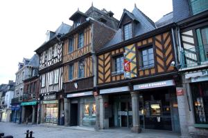 a row of buildings on a city street at Hôtel MAEN-HIR Dol Gare in Dol-de-Bretagne