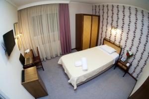 Posteľ alebo postele v izbe v ubytovaní Olympos Hotel