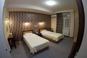 Posteľ alebo postele v izbe v ubytovaní Olympos Hotel