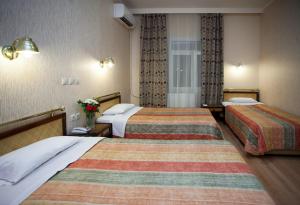 Posteľ alebo postele v izbe v ubytovaní Olympos Hotel