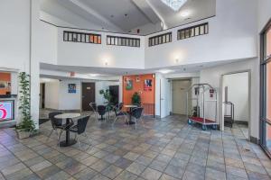 an empty room with chairs and tables in a building at Motel 6-Lawrence, KS in Lawrence