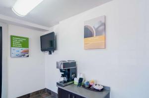 a room with a coffee machine and a tv on the wall at Motel 6-Oklahoma City, OK - South in Oklahoma City