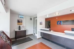 a lobby of a convenience store with orange and white walls at Motel 6-Overland Park, KS in Overland Park