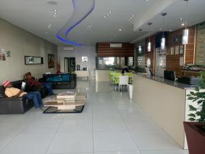 two people sitting on couches in a living room at The Union Hotel in Durban
