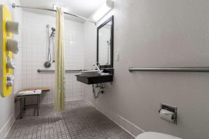a bathroom with a sink and a mirror at Motel 6 Riverside, CA - UCR East in Riverside +20 photos