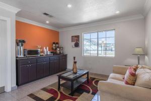 a living room with a couch and a table at Motel 6-Kingsburg, CA in Kingsburg