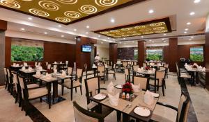 a restaurant with tables and chairs in a room at Lords Inn Jodhpur in Jodhpur