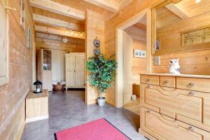 una habitación con paredes de madera y un gato sentado en una cómoda en Haus Edelweiss en Brand