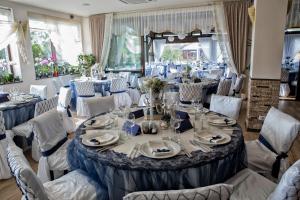 - une salle de banquet avec des tables, des chaises, des assiettes et des serviettes dans l'établissement Armonia by Aristocratis, à Tîrgu Neamţ