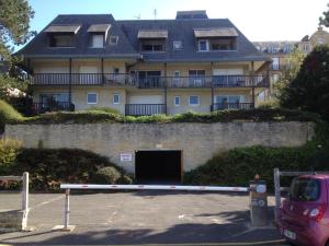 a large building with a tunnel in front of it at Residence le Crisenoy in Houlgate