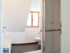 a bathroom with a toilet and a window at Gastezimmer Richter in Dresden