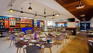 um restaurante com mesas e cadeiras e um bar em Zone By The Park, ORR, Chennai em Chennai