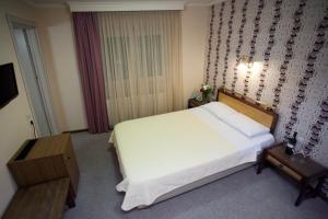 Posteľ alebo postele v izbe v ubytovaní Olympos Hotel