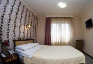 Posteľ alebo postele v izbe v ubytovaní Olympos Hotel