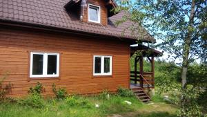 a small house with a staircase leading up to it at Domek nad morzem Mechowo in Mechowo