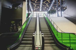 an escalator in a building with green stairs at Hotel Skt Petri in Copenhagen