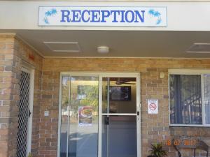 a restaurant entrance with a sign above the door at Forster Palms Motel in Forster +49 photos