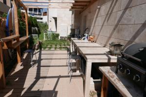 a patio with a row of tables and a grill at Apolonia Resort Apartments in Sozopol