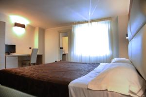 Postel nebo postele na pokoji v ubytování Hotel Sogni D'Oro Airport
