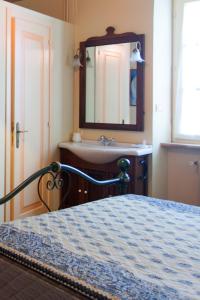 a bedroom with a bed and a sink and a mirror at Montelupone Bed & Breakfast in Montelupone