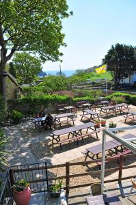 a group of picnic tables in a park at Lulworth Cove Inn in Lulworth Cove