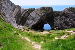 a cave in the rocks near the ocean at Lulworth Cove Inn in Lulworth Cove