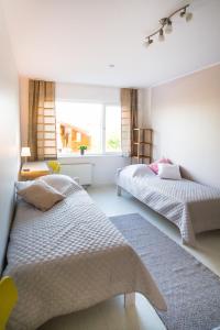 a bedroom with two beds and a window at Tamme Flint in Tartu