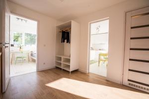a living room with a door open to a dining room at Tamme Flint in Tartu