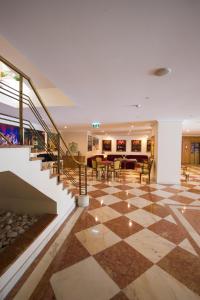 a lobby with a checkerboard floor and stairs at Vila Galé Estoril in Estoril