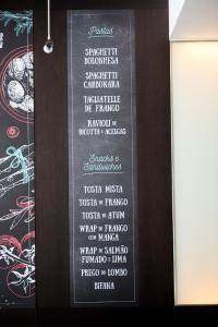a menu for a restaurant with a black board with food at Vila Galé Estoril in Estoril