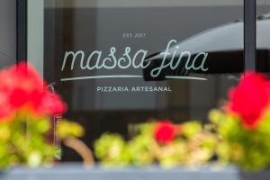a sign for a restaurant with flowers in a window at Vila Galé Estoril in Estoril