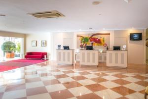 a lobby with a checkered floor and a red couch at Vila Galé Estoril in Estoril +37 photos