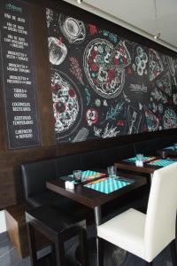 a restaurant with a chalkboard wall with a table and chairs at Vila Galé Estoril in Estoril