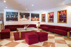 a living room with red couches and a table at Vila Galé Estoril in Estoril