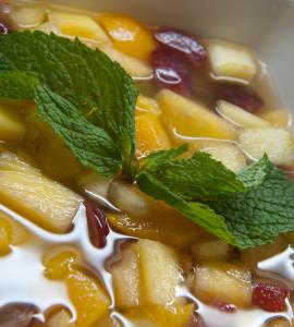 a bowl of soup with fruit and mint on top at Vila Galé Estoril in Estoril