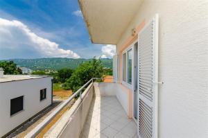 a balcony with a door and a view of the mountains at Apartment in Novi Vinodolski 15308 in Novi Vinodolski