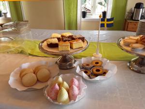 a table with three trays of different types of pastries at Stegeborgsgården in Norrkrog