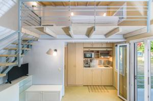 a staircase in a kitchen with white walls and ceilings at Camping Valti Houses in Sarti