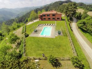 an aerial view of a house on a hill with a swimming pool at Expansive Villa in Tredozio Tuscany with Panoramic Views in Tredozio