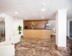 an office lobby with a reception desk and marble floors at Sunday's Beach in Peniscola
