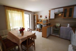 a kitchen and dining room with a table and chairs at Apartments in Dramalj 5747 in Dramalj