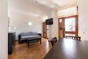 a living room with a table and a couch at Apartamentos Don Pedro in Playa del Ingles +40 photos