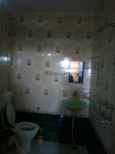 a bathroom with a toilet and a sink and a mirror at Milkman Guest House in Pushkar