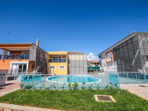 a swimming pool in front of some buildings at Apartment in Funtana with Three-Bedrooms 1 in Funtana