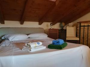 a bedroom with a bed with towels on it at La Calletta in Rovinj