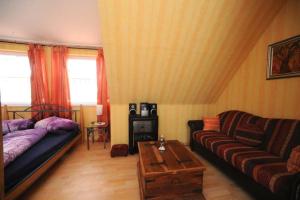 a living room with a couch and a table at Phönix aus der Asche in Rhodt unter Rietburg